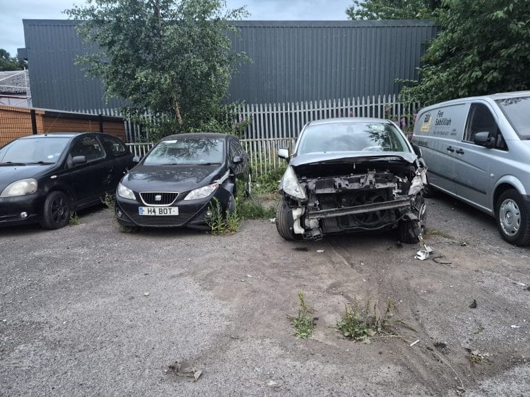 Accident-damaged and scrap cars in a recovery yard
