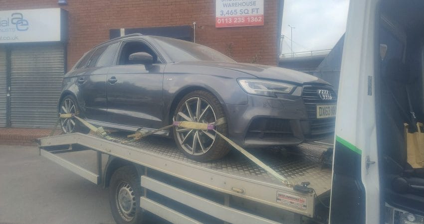 Recovery truck transporting a damaged car in South Yorkshire