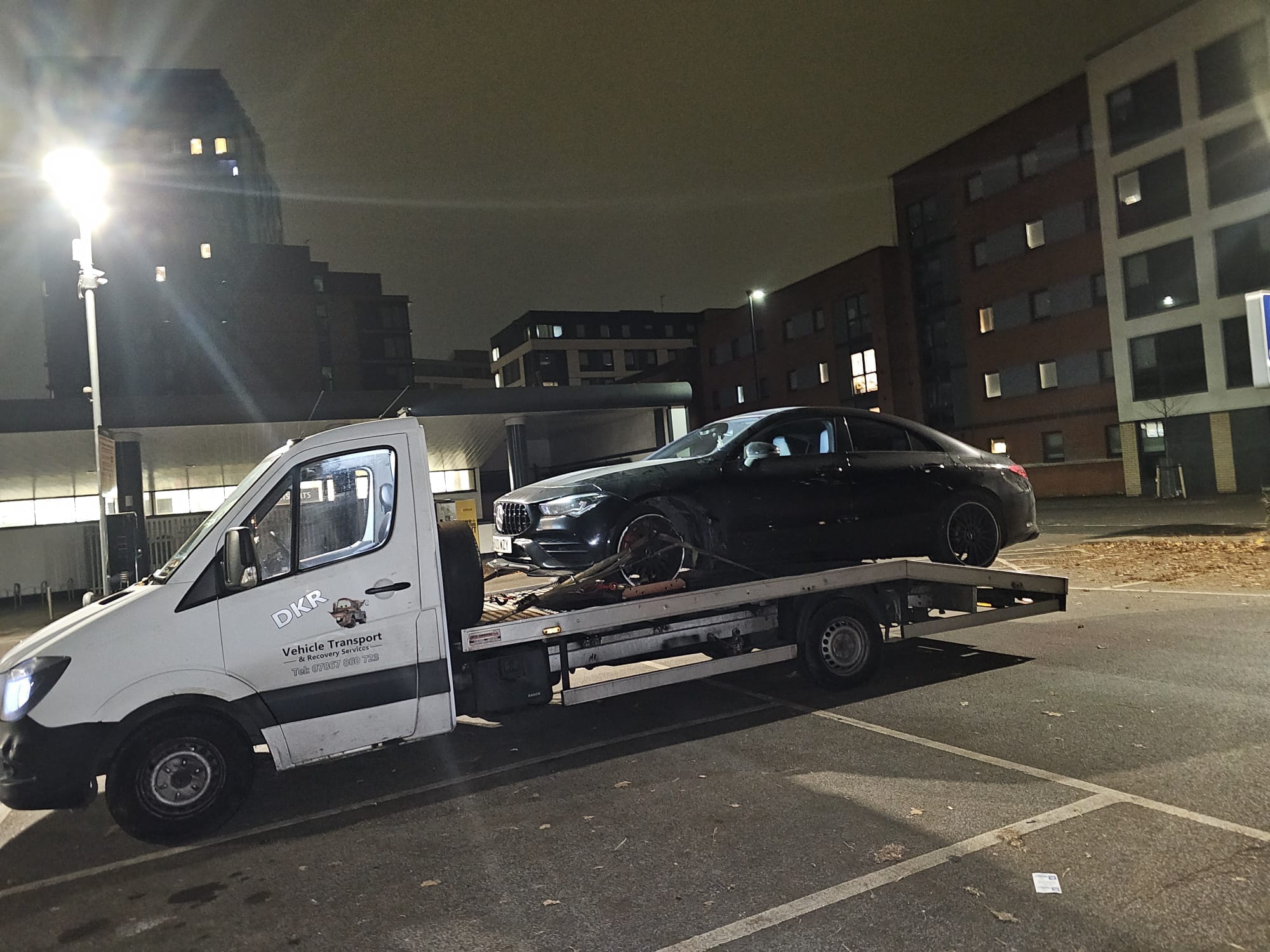 DK’s Recovery truck with a car loaded at night