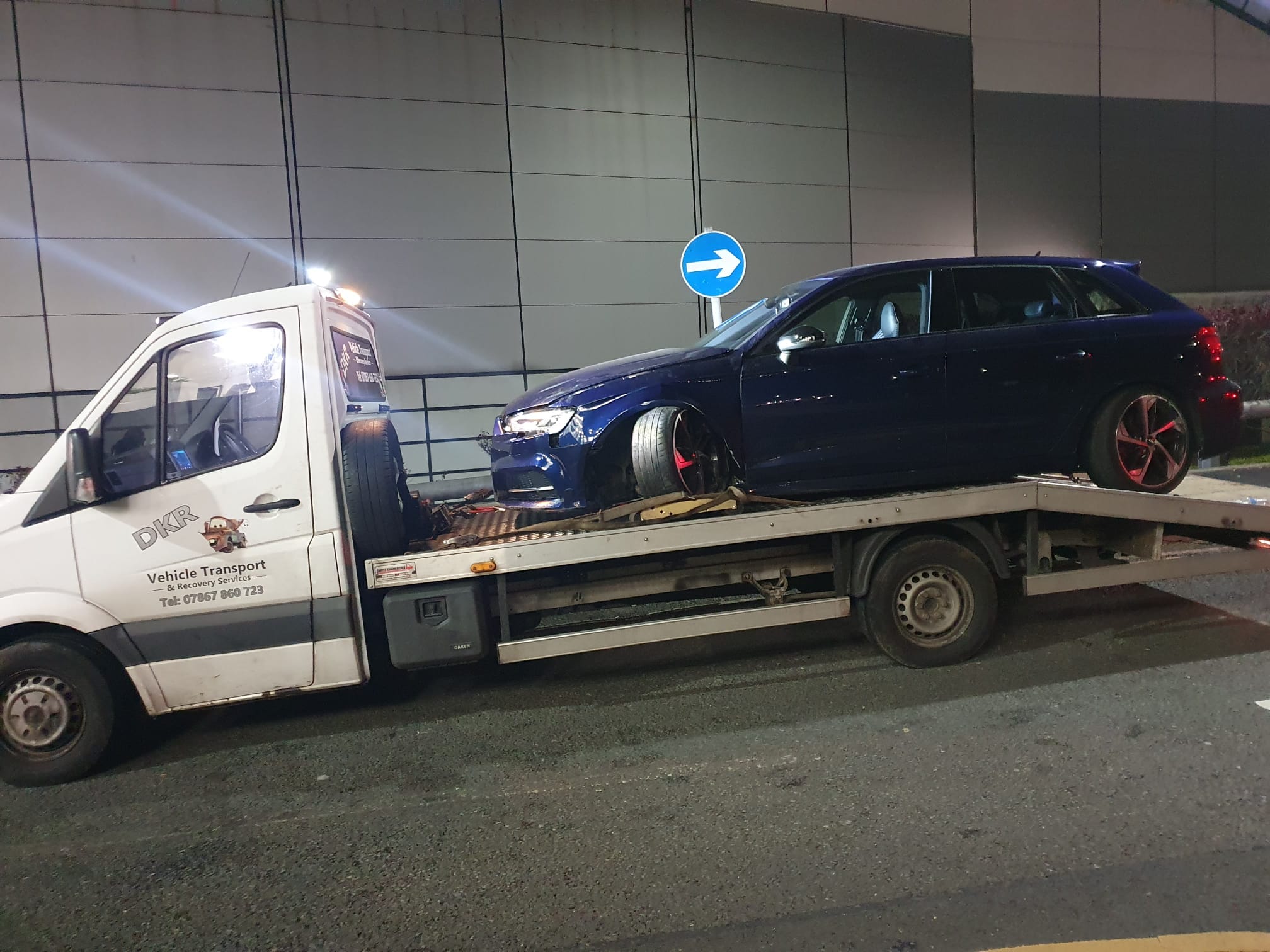 DK’s Recovery flatbed with a car loaded at the roadside